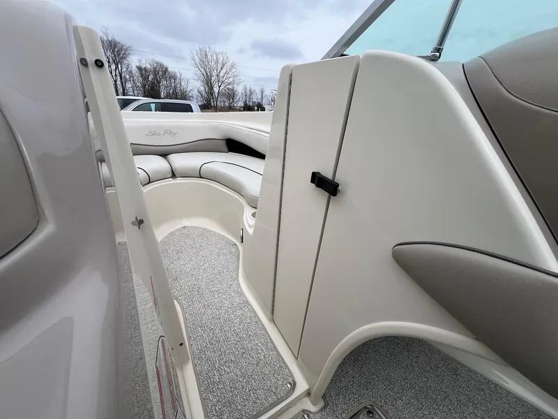 Slide: The Image of 2003 Sea Ray 200 Bow Rider interior with seating and carpeted flooring. - 12