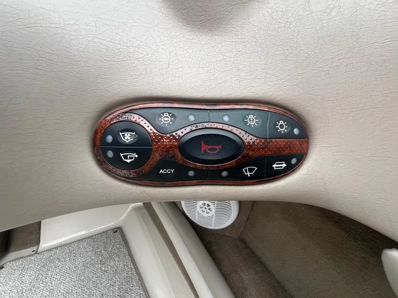 Slide: The Image of Control panel of a 2003 Sea Ray 200 Bow Rider boat with various function buttons. - 15
