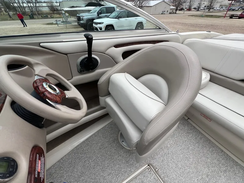 Slide: The Image of 2003 Sea Ray 200 Bow Rider interior with steering wheel and seating. - 17