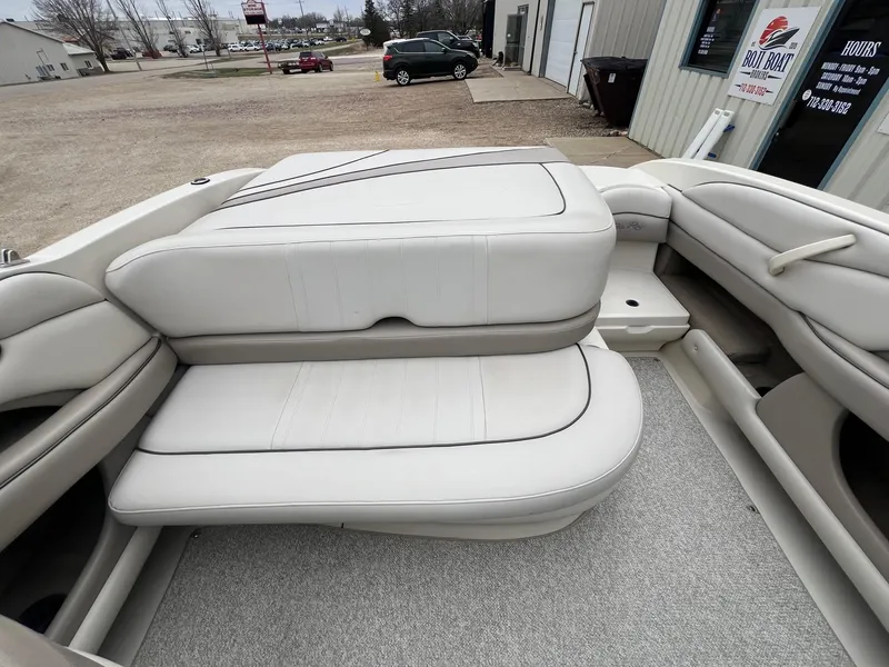 Slide: The Image of 2003 Sea Ray 200 Bow Rider interior with white cushioned seating. - 19