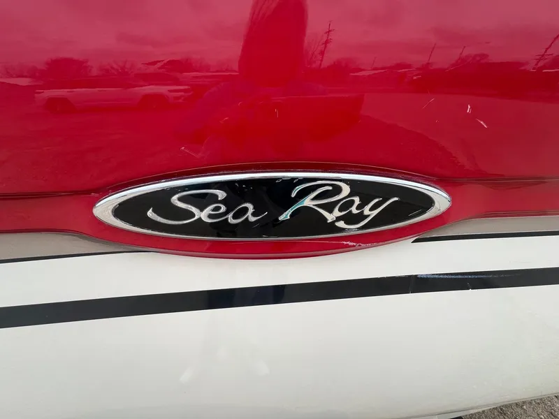 Slide: The Image of Sea Ray 2003 200 Bow Rider logo on red and white boat exterior. - 2
