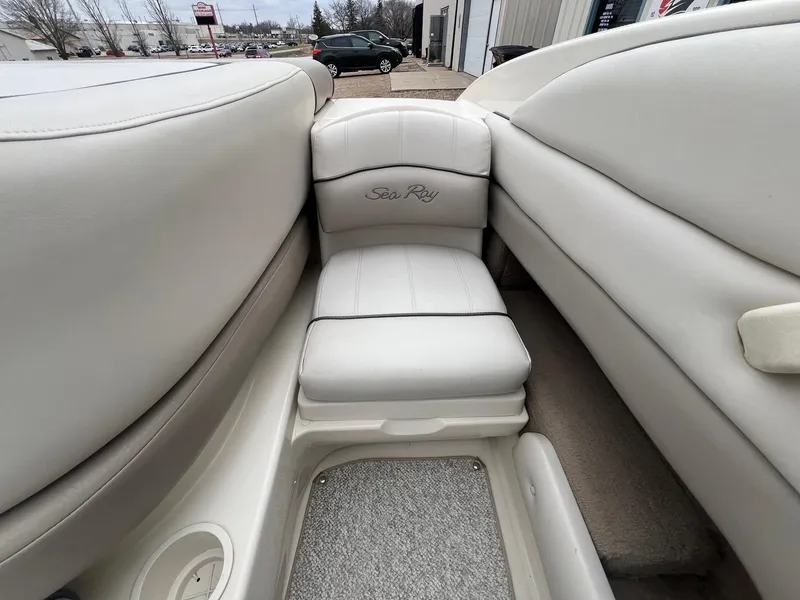 Slide: The Image of 2003 Sea Ray 200 Bow Rider interior with white leather seating and carpeted flooring. - 21