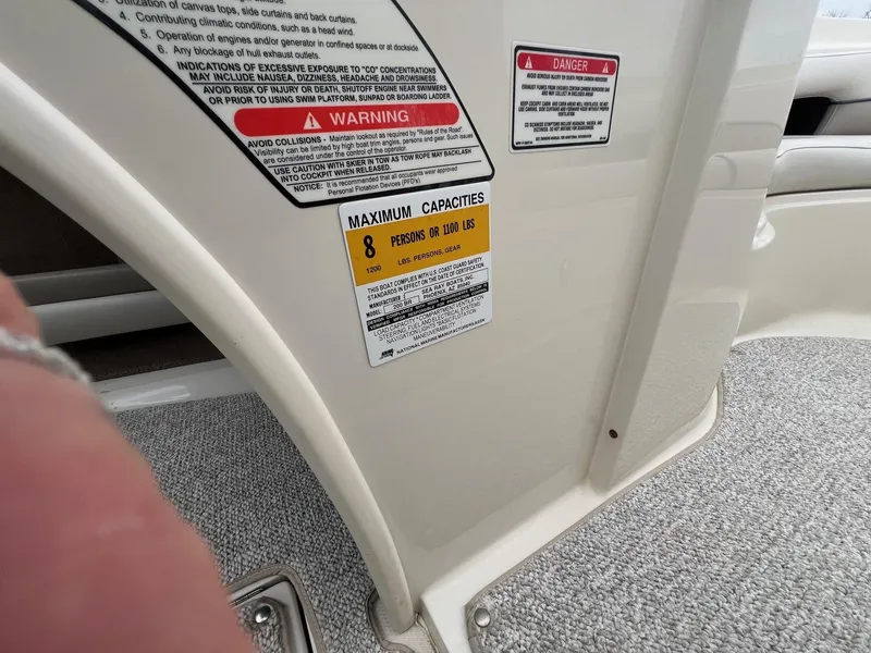 Slide: The Image of 2003 Sea Ray 200 Bow Rider capacity warning labels, maximum 8 persons or 1200 lbs. - 24