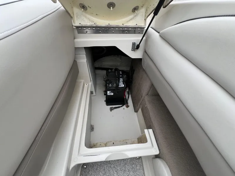 Slide: The Image of 2003 Sea Ray 200 Bow Rider battery compartment with open hatch. - 25