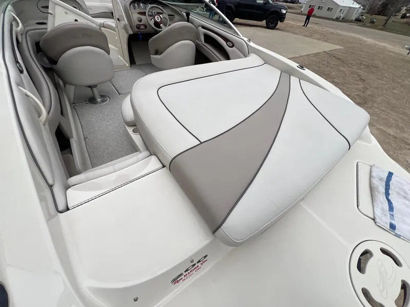Slide: The Image of 2003 Sea Ray 200 Bow Rider interior with seating and dashboard view. - 27