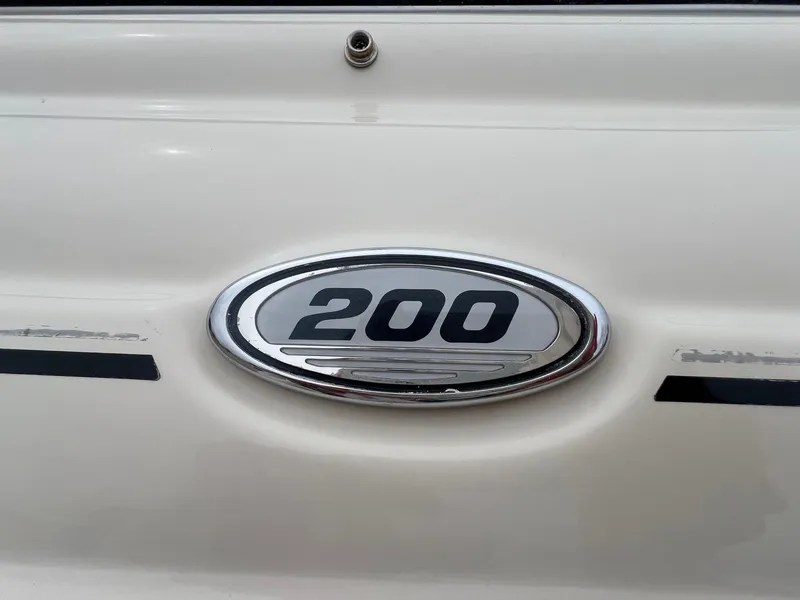 Slide: The Image of 2003 Sea Ray 200 Bow Rider emblem on white boat exterior. - 3