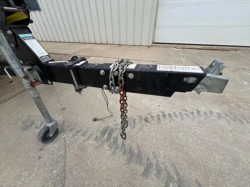 Slide: The Image of Trailer hitch of a 2003 Sea Ray 200 Bow Rider with safety chains on concrete. - 30