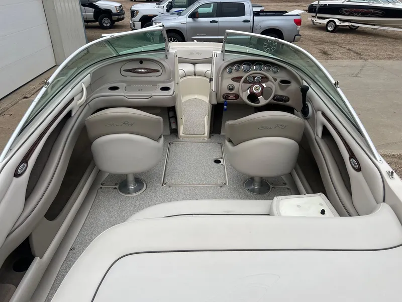 Slide: The Image of 2003 Sea Ray 200 Bow Rider interior with steering wheel and seating. - 7