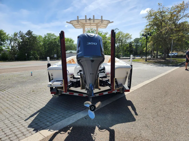 Slide: The Image of 2018 Pathfinder 2500 Hybrid boat with 300 HP engine on trailer, parked outdoors. - 12