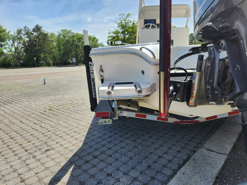 Slide: The Image of 2018 Pathfinder 2500 Hybrid boat on trailer, parked on paved surface. - 16
