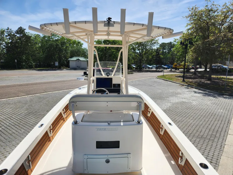 Slide: The Image of 2018 Pathfinder 2500 Hybrid boat with center console and T-top, parked on paved area. - 25