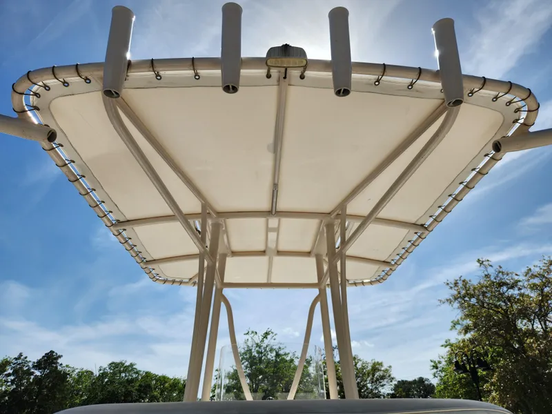 Slide: The Image of T-top canopy of a 2018 Pathfinder 2500 Hybrid boat against a clear blue sky. - 26
