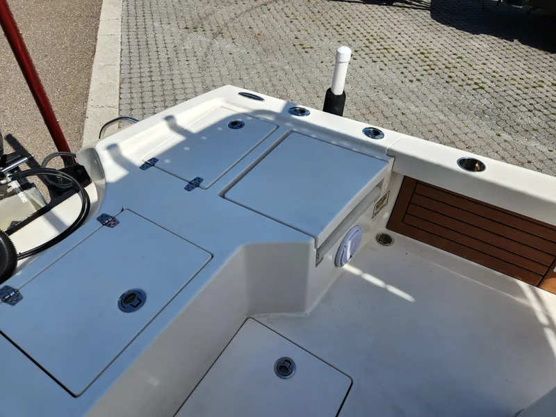 Slide: The Image of 2018 Pathfinder 2500 Hybrid boat deck with storage compartments and rod holders. - 29
