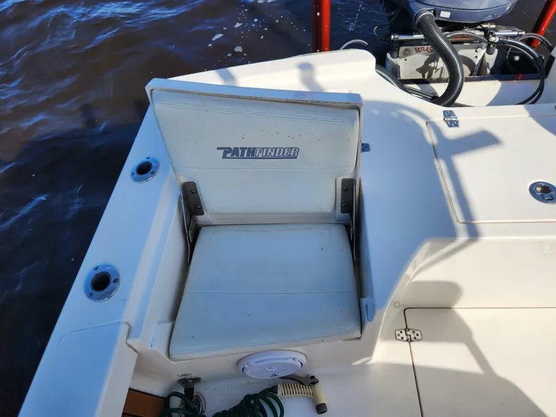 Slide: The Image of Pathfinder 2500 Hybrid boat seat, 2018 model, on deck near water. - 31