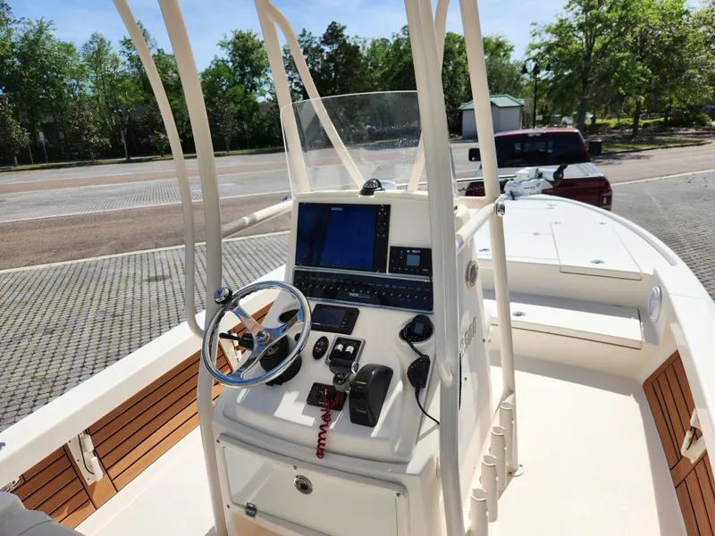 Slide: The Image of 2018 Pathfinder 2500 Hybrid boat console with steering wheel and navigation equipment. - 33