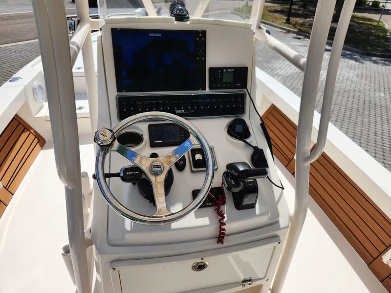 Slide: The Image of 2018 Pathfinder 2500 Hybrid boat console with steering wheel and navigation controls. - 34