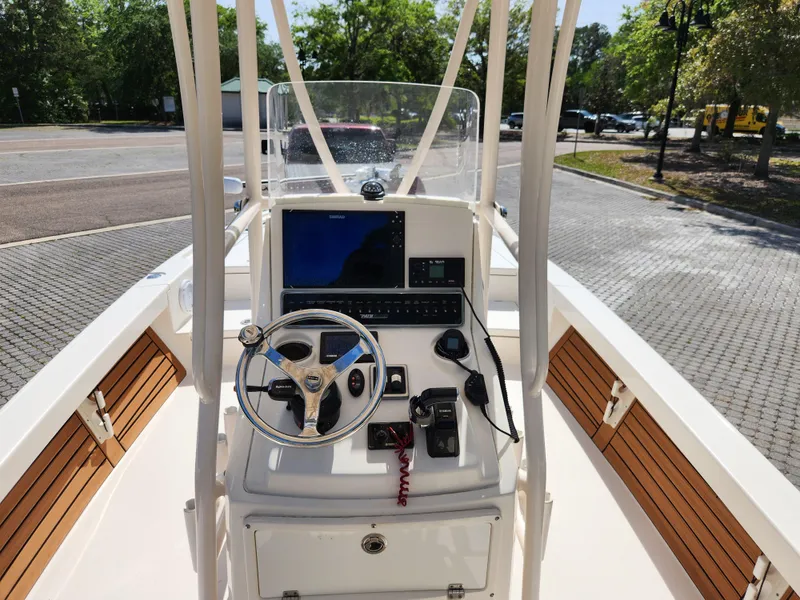 Slide: The Image of 2018 Pathfinder 2500 Hybrid boat console with steering wheel and navigation equipment. - 36