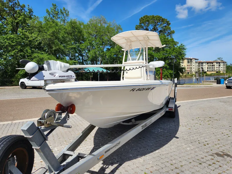 Slide: The Image of 2018 Pathfinder 2500 Hybrid boat on trailer in sunny outdoor setting. - 4