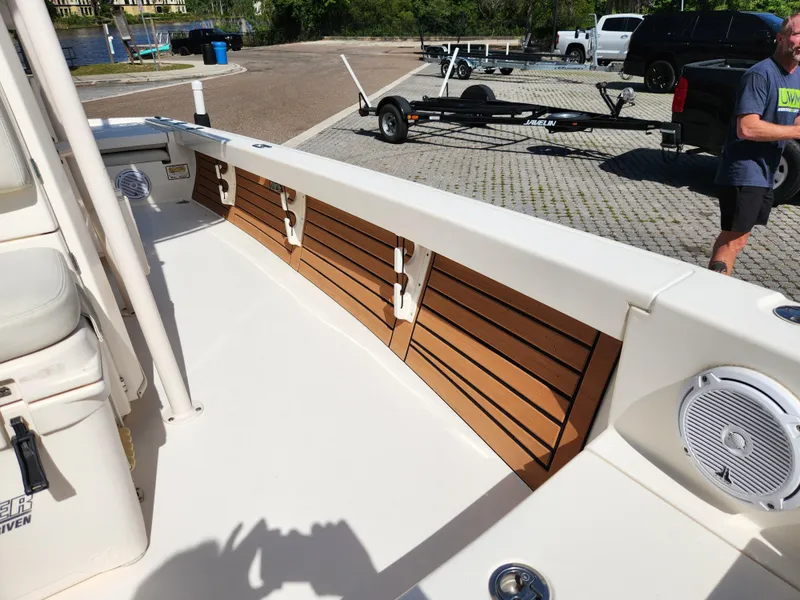 Slide: The Image of 2018 Pathfinder 2500 Hybrid boat interior with wood paneling and speaker. - 40