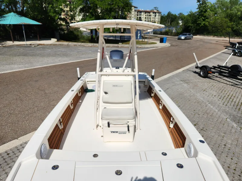 Slide: The Image of 2018 Pathfinder 2500 Hybrid boat at dock, featuring spacious deck and seating. - 42