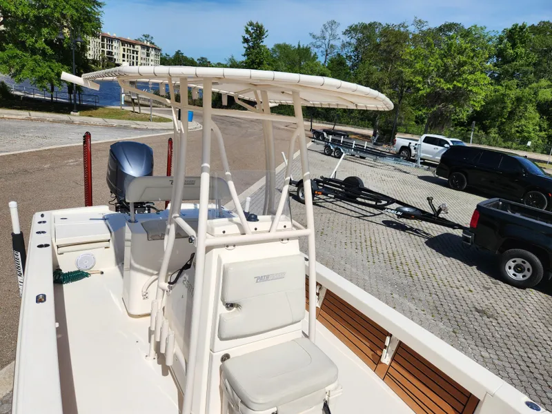 Slide: The Image of 2018 Pathfinder 2500 Hybrid boat with T-top, parked on a trailer in a sunny lot. - 44