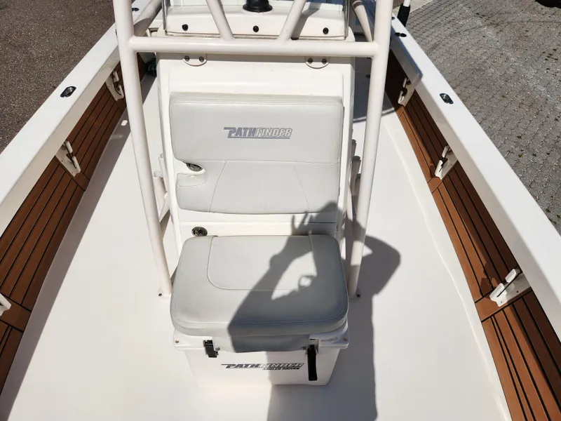 Slide: The Image of 2018 Pathfinder 2500 Hybrid boat interior with cushioned seating and wooden accents. - 45