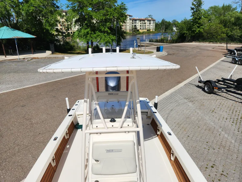 Slide: The Image of 2018 Pathfinder 2500 Hybrid boat docked near a scenic waterfront area. - 46