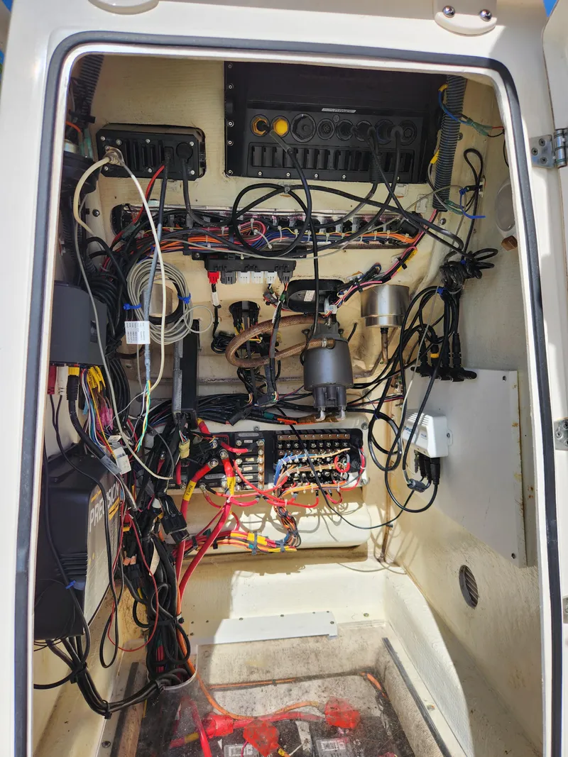 Slide: The Image of Electrical wiring inside a 2018 Pathfinder 2500 Hybrid boat, showcasing complex circuitry and components. - 49