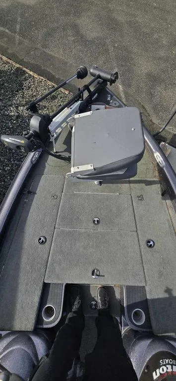 Slide: The Image of 2003 Triton TR-20 boat deck with trolling motor and carpeted surface. - 4