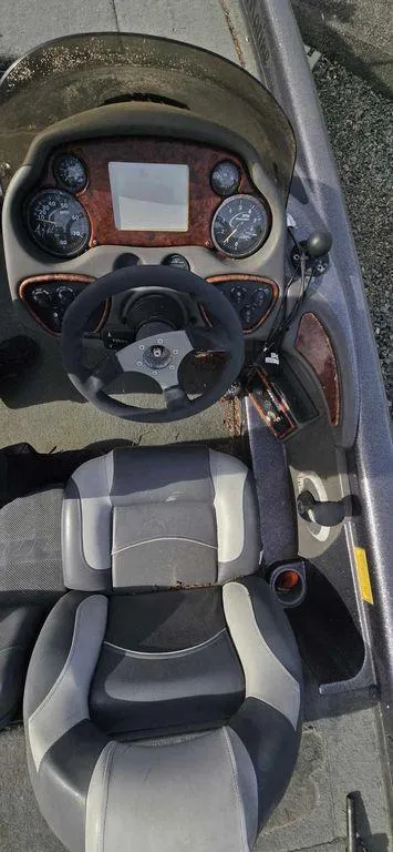 Slide: The Image of 2003 Triton TR-20 boat cockpit with steering wheel and dashboard controls. - 5