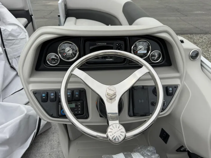 Slide: The Image of Steering console of 2025 South Bay 224UL boat with gauges and controls. - 11