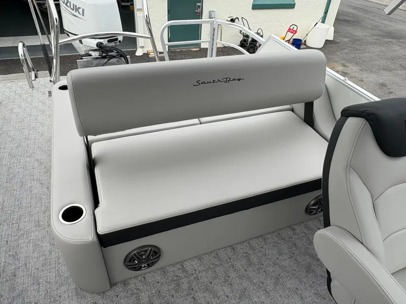 Slide: The Image of 2025 South Bay 224UL boat interior with gray seating and cup holders. - 22