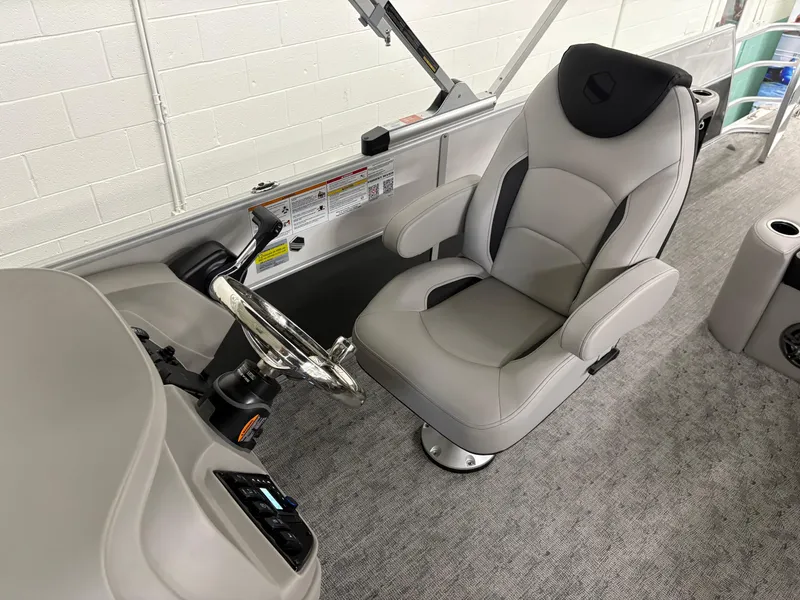 Slide: The Image of 2025 South Bay 224UL boat interior with captain's chair and steering wheel. - 25