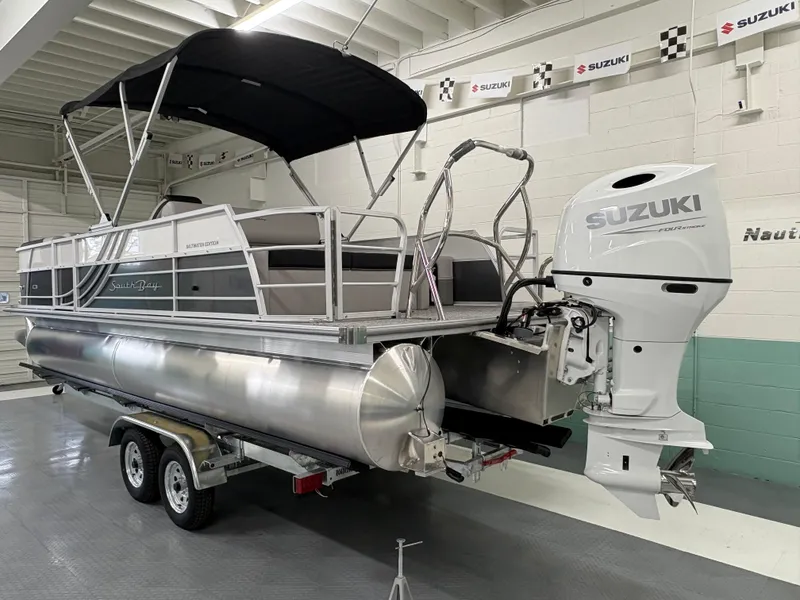 Slide: The Image of 2025 South Bay 224UL pontoon boat with Suzuki outboard motor on trailer. - 3