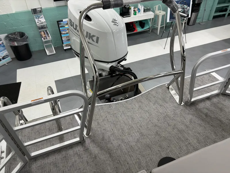 Slide: The Image of 2025 South Bay 224UL pontoon boat with Suzuki outboard motor in showroom. - 30
