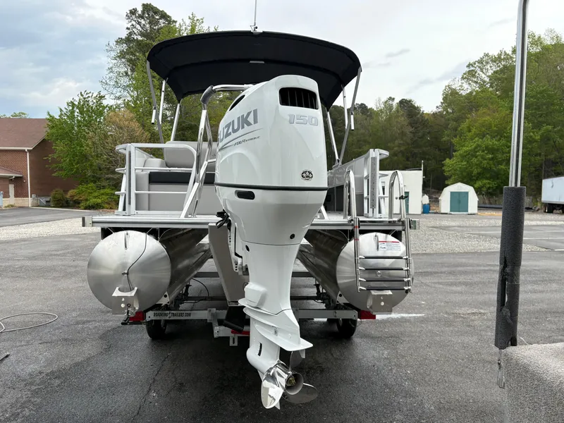Slide: The Image of 2025 South Bay 224UL pontoon boat with Suzuki outboard motor, parked outdoors. - 6