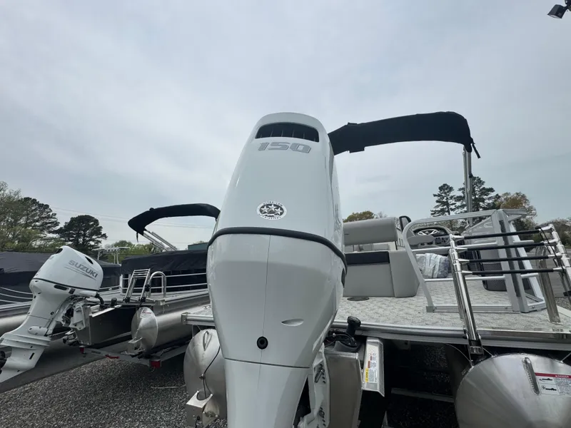 Slide: The Image of 2025 South Bay 224UL pontoon boat with powerful outboard motor, docked outdoors. - 7