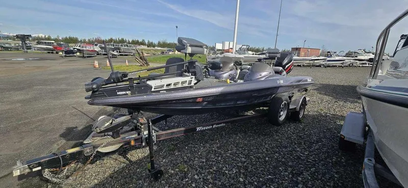 Slide: The Image of 2002 Arima Sea Ranger 19 boat on trailer in a marina setting. - 1