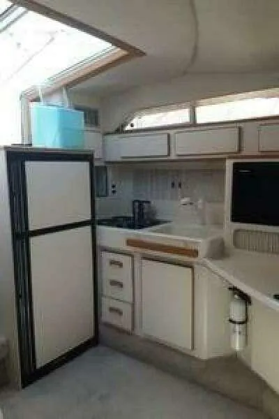 Slide: The Image of 1993 Sea Ray 400 Sundancer helm with steering wheel and control panel. - 8