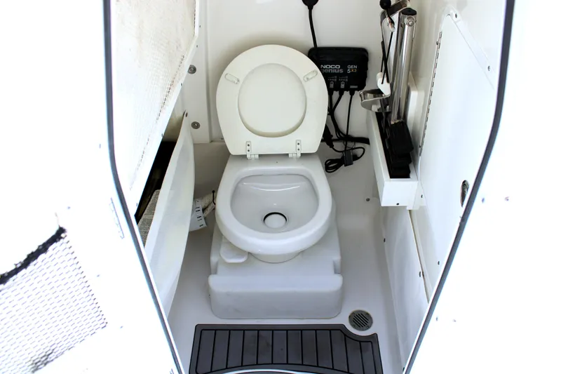 Slide: The Image of 2022 Sea Hunt Gamefish 27 boat interior with toilet and storage features. - 11