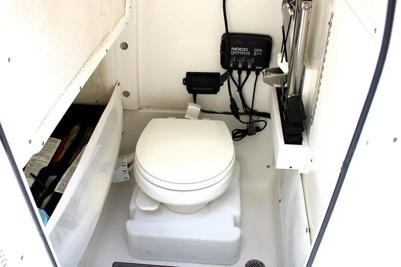 Slide: The Image of 2022 Sea Hunt Gamefish 27 boat interior with toilet and storage compartment. - 12