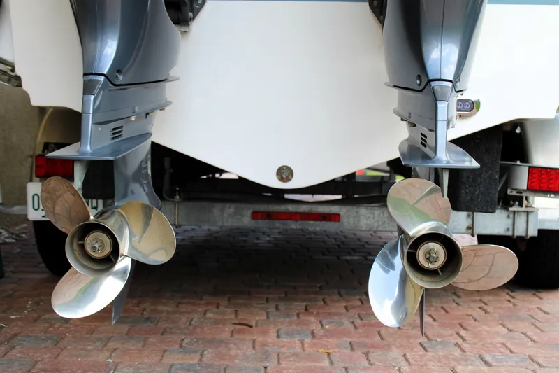 Slide: The Image of Twin propellers of a 2022 Sea Hunt Gamefish 27 with Coffin Box on a trailer. - 14