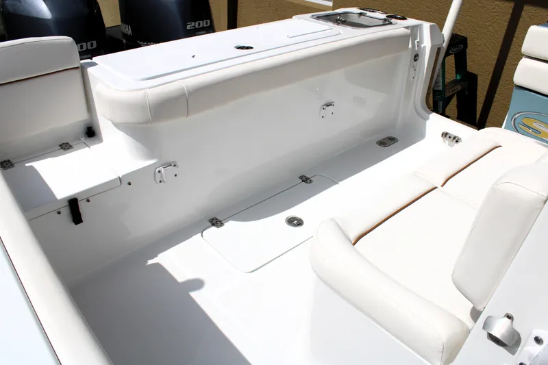 Slide: The Image of 2022 Sea Hunt Gamefish 27 interior with coffin box, featuring white seating and storage. - 21