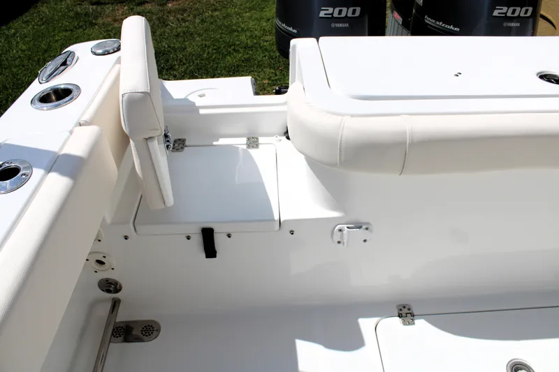 Slide: The Image of 2022 Sea Hunt Gamefish 27 with Coffin Box, featuring sleek white seating and storage compartments. - 24