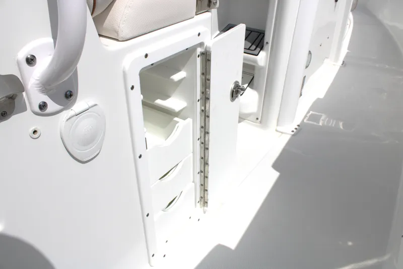 Slide: The Image of 2022 Sea Hunt Gamefish 27 storage compartment with open door and drawers. - 27