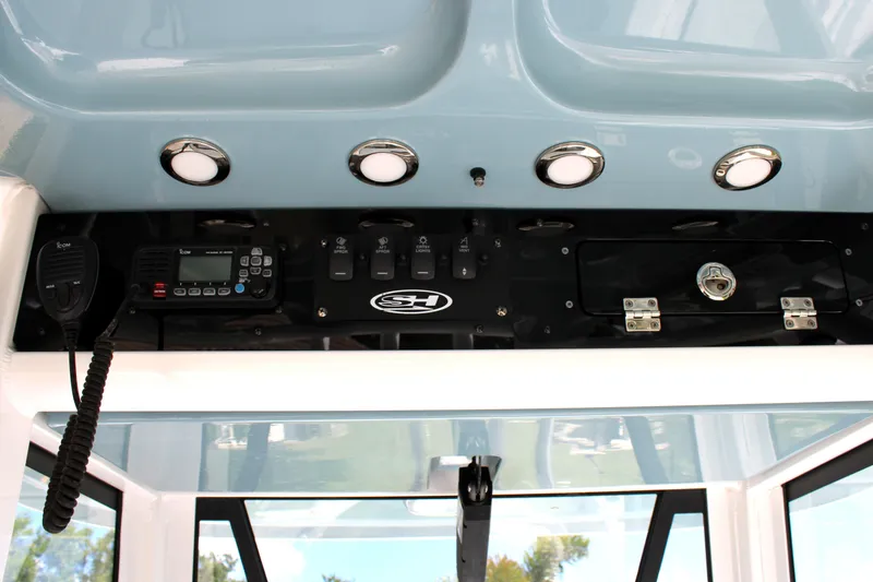 Slide: The Image of 2022 Sea Hunt Gamefish 27 control panel with radio and switches. - 32