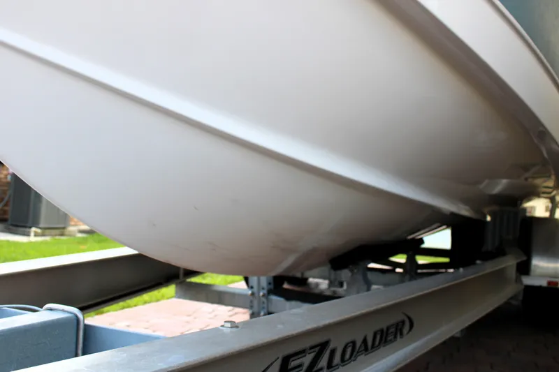 Slide: The Image of 2022 Sea Hunt Gamefish 27 on EZ Loader trailer, side view of hull. - 42