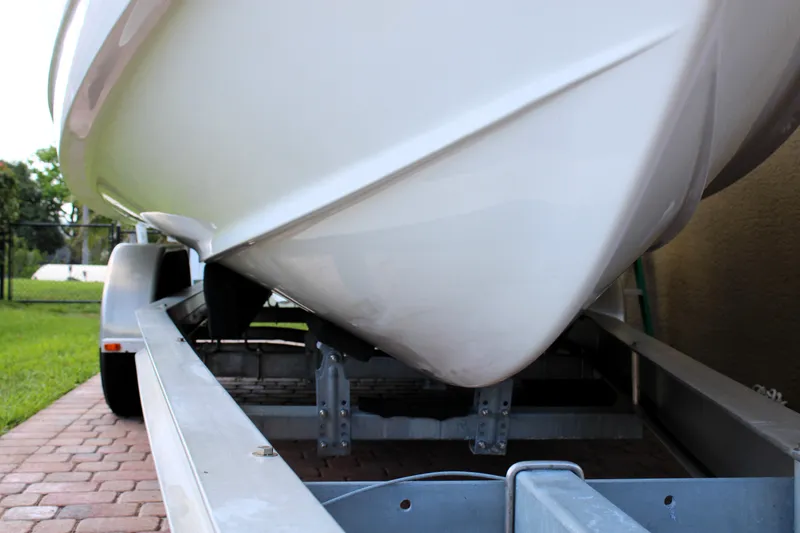 Slide: The Image of 2022 Sea Hunt Gamefish 27 boat on trailer, side view, parked on brick driveway. - 43