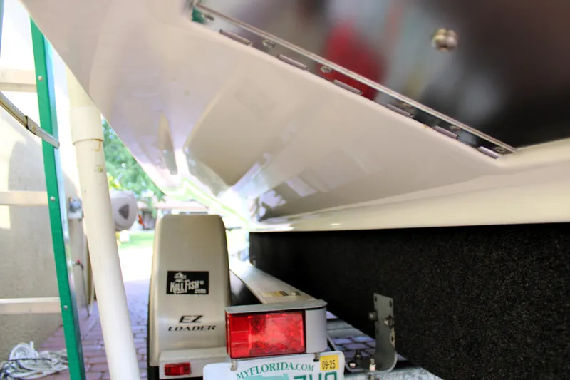 Slide: The Image of 2022 Sea Hunt Gamefish 27 on trailer, showcasing hull and trailer details. - 44