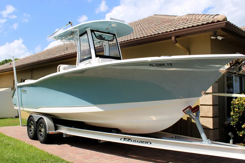 Slide: The Image of 2022 Sea Hunt Gamefish 27 with Coffin Box on trailer, parked beside a house. - 47
